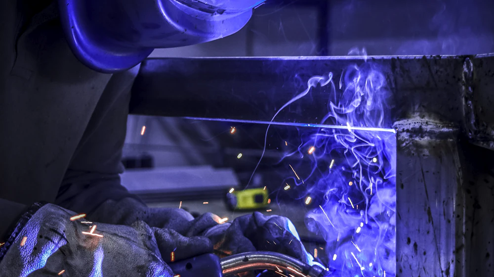 Welder joining a steel frame
