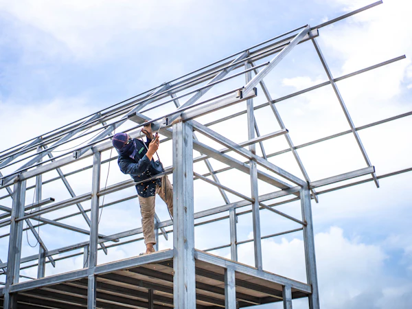 Worker assembling a structural steel frame